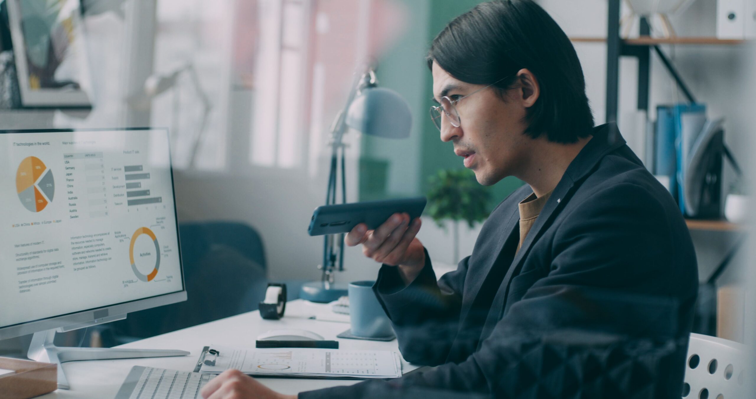 Man on the phone looking at an analytics dashboard