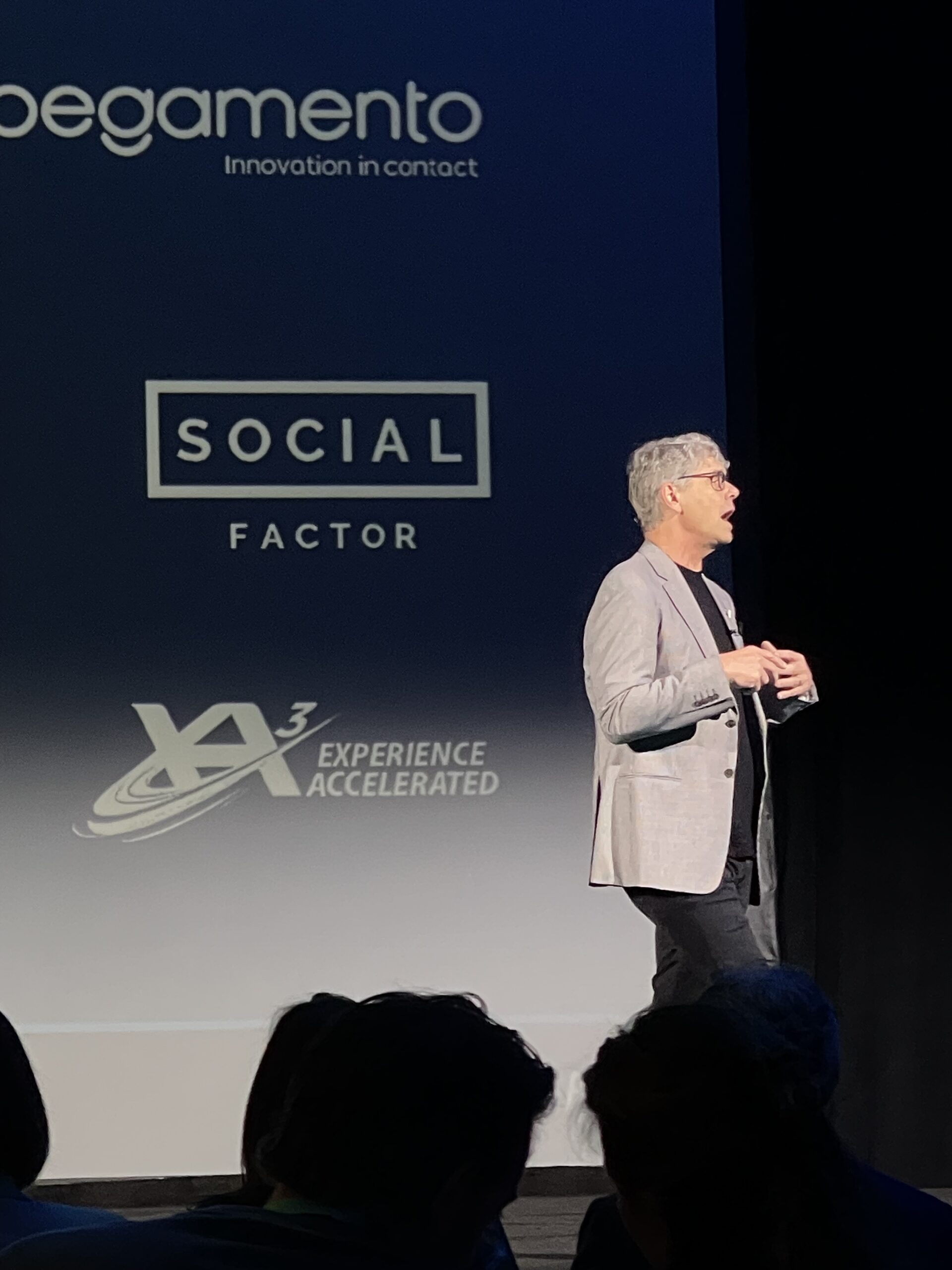 Presenter on stage speaking.