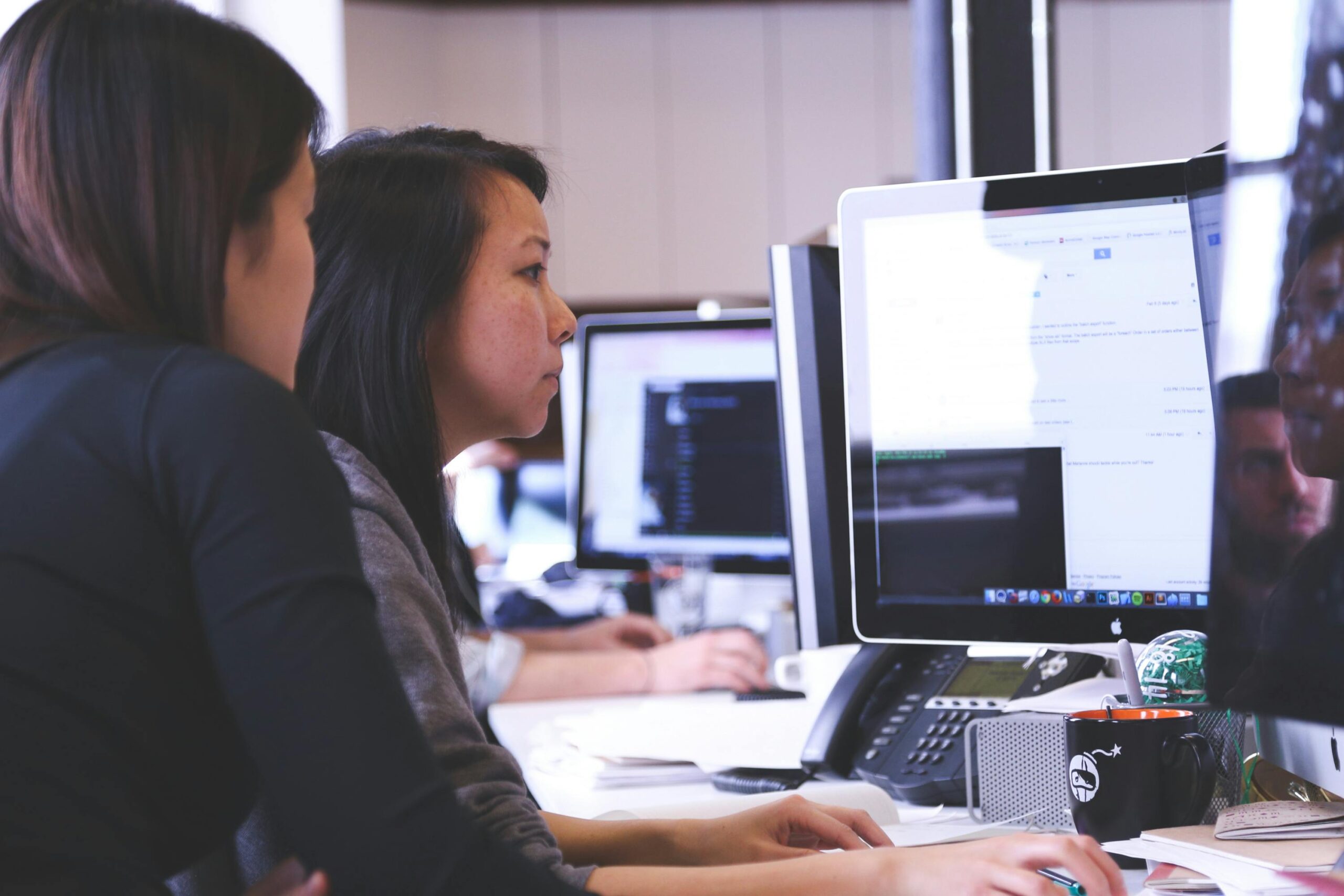 Two women at a computer working