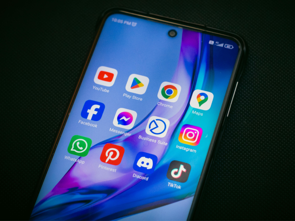 A bunch of social media apps on the home screen of a cell phone