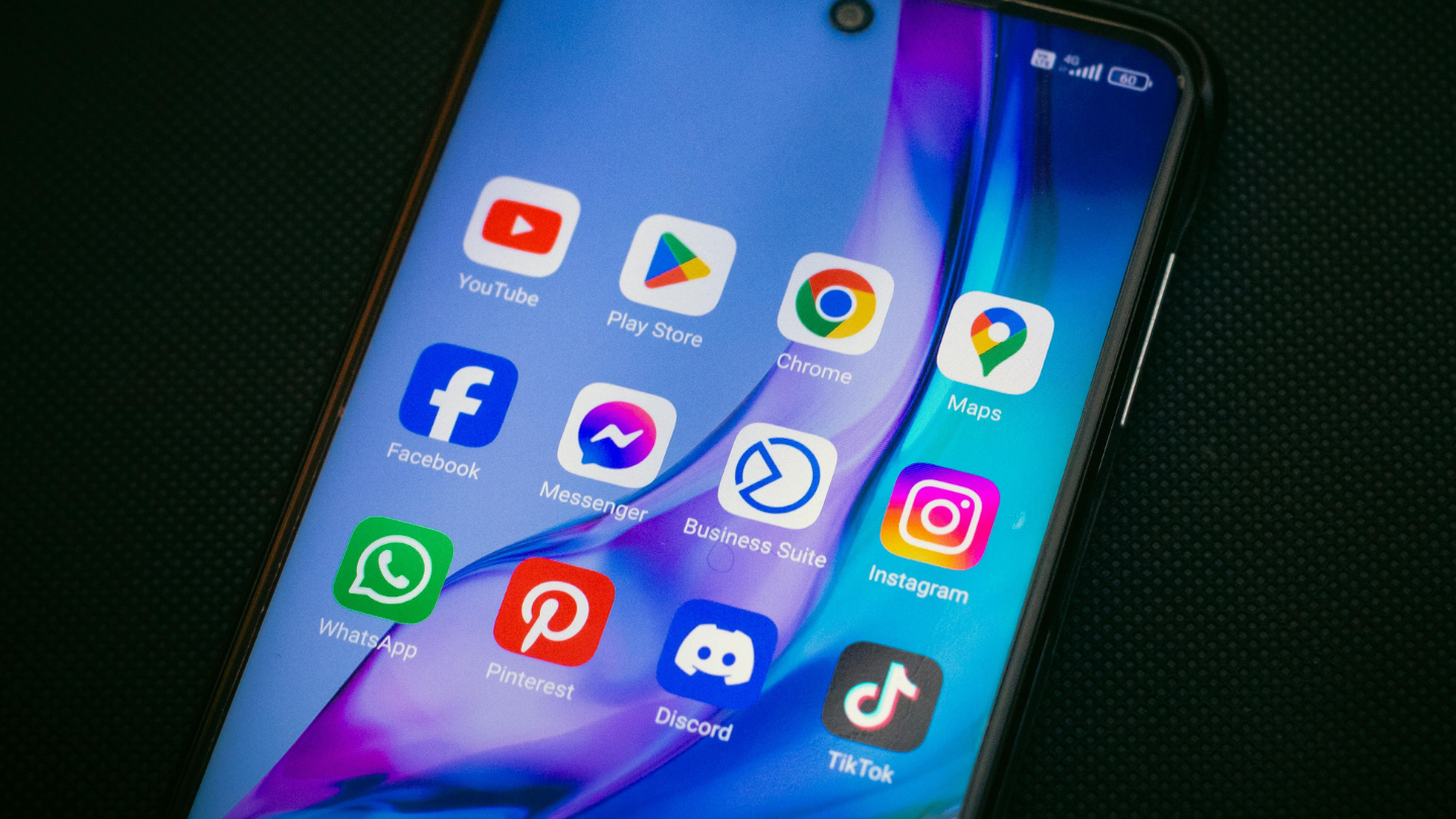 A bunch of social media apps on the home screen of a cell phone