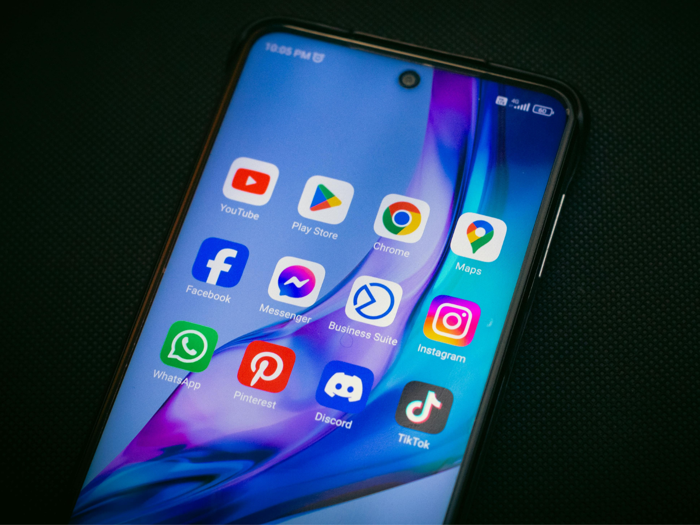 A bunch of social media apps on the home screen of a cell phone