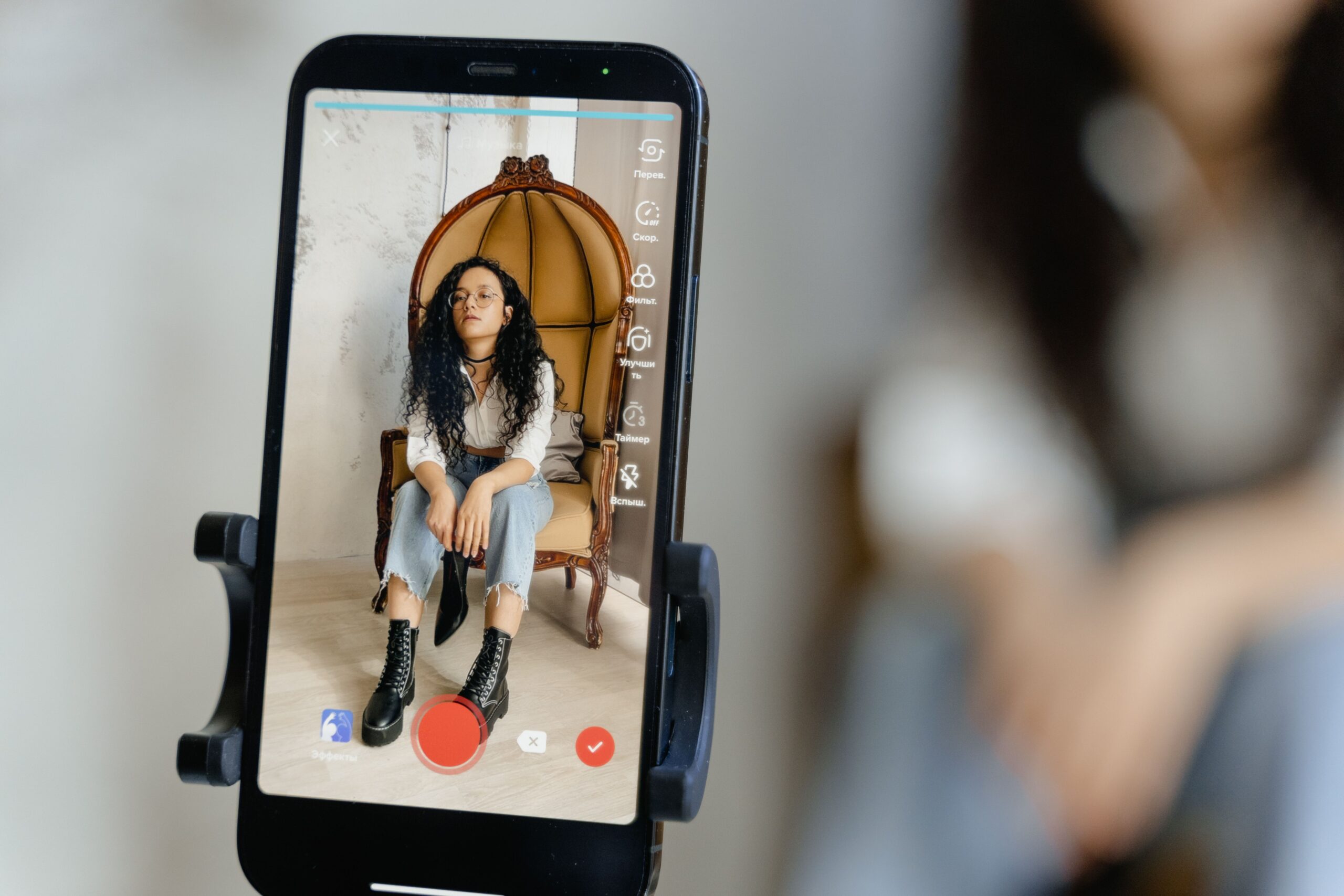 A person filming content on their smartphone