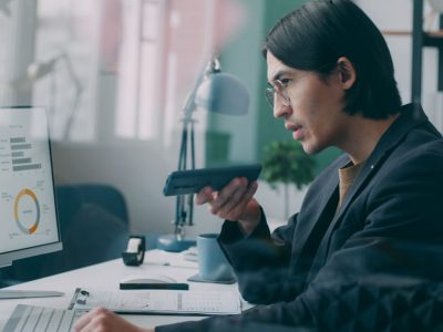 Man on the phone looking at an analytics dashboard